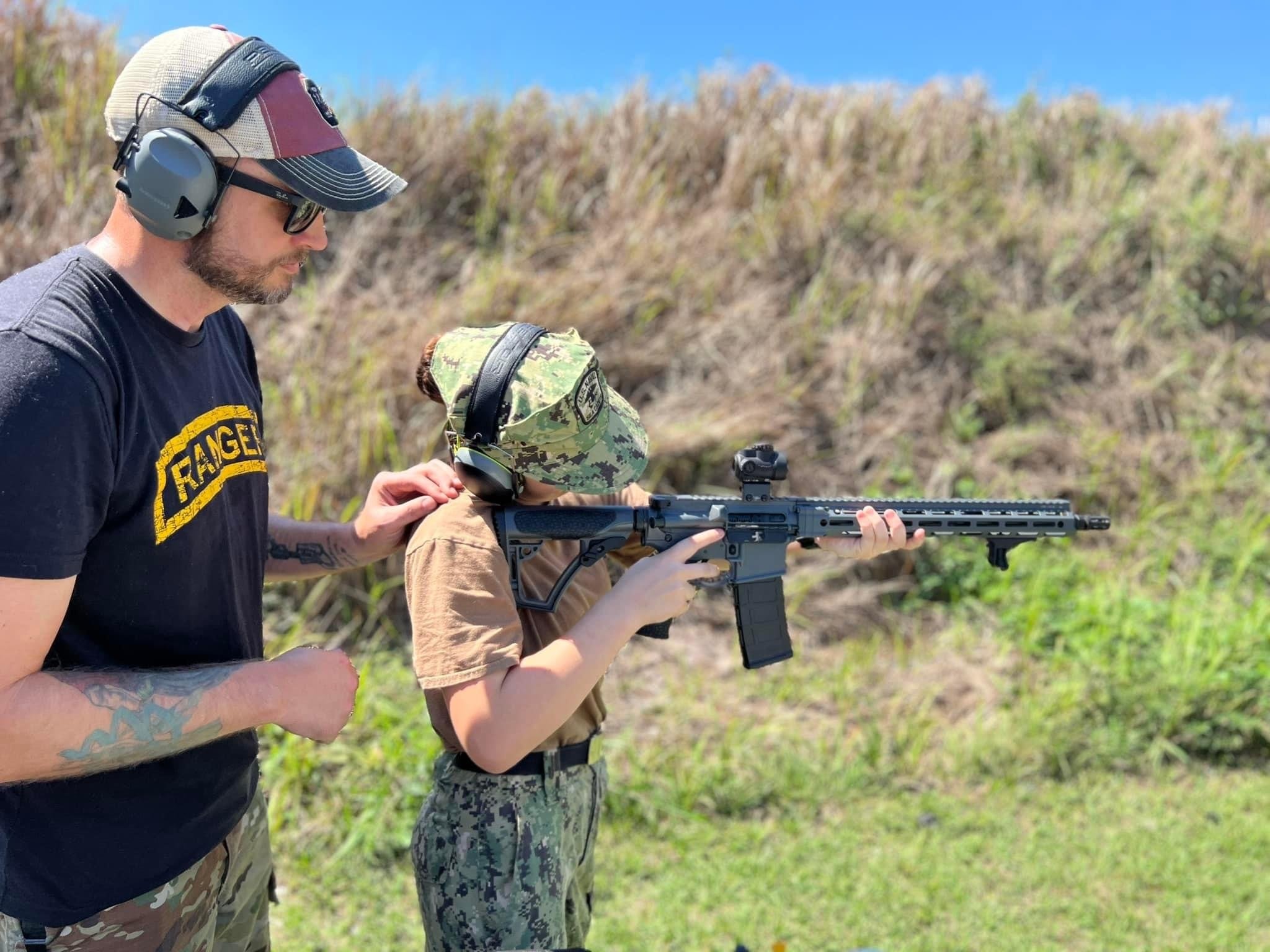 Chris Pollitzer mentoring a young shooter at a range
